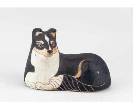 † ROSEMARY WREN (1922-2013) for Oxshott Pottery; a stoneware sculpture of a reclining dog, painted by Peter Crotty, impressed