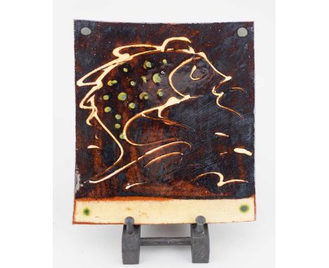 † CLIVE BOWEN (born 1943); a large slipware tile decorated with a fish, 23 x 20.5cm.Condition Report: Appears good with no ob