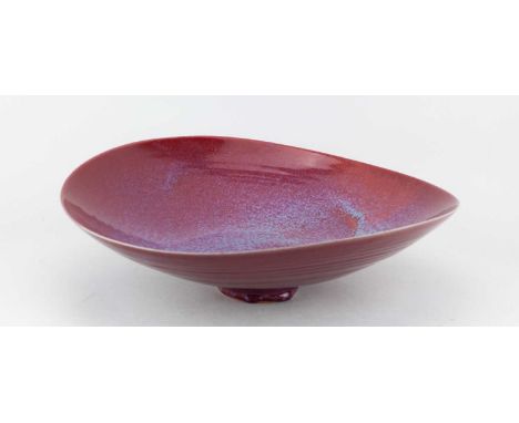 † RUPERT SPIRA (born 1960); a large stoneware bowl with wavy rim covered in copper red glaze mottling to copper green to the 