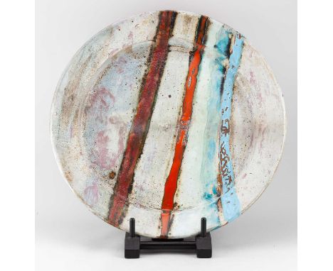 † ROBIN WELCH (1936-2019); a monumental stoneware platter predominantly covered in pale grey glaze with bands of polychrome e