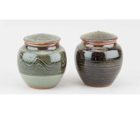 Winchcombe Pottery; a near pair of stoneware jars and covers, one partially covered speckled grey glaze with meander decorati