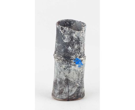 † ROBIN WELCH (1936-2019); a cylindrical stoneware vessel with torn rim partially covered in mottled pale grey glaze with blu