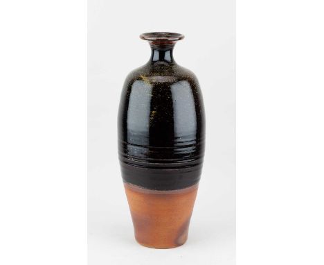 Winchcombe Pottery; a tall stoneware bottle partially covered in tenmoku breaking to kaki glaze with tea dust glaze to the sh