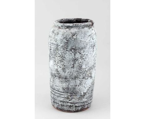 † ROBIN WELCH (1936-2019); a tall cylindrical stoneware vessel covered in mottled pale grey glaze with red enamel highlights 