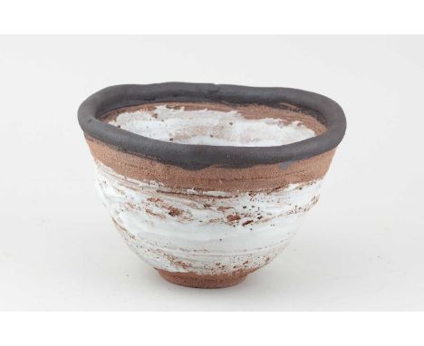 † ROBIN WELCH (1936-2019); a stoneware bowl partially covered in white glaze with black rim, diameter 20cm.Provenance: Estate