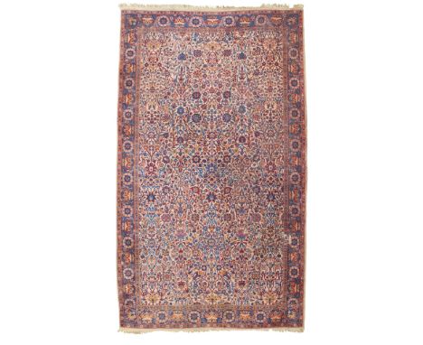 LARGE TABRIZ CARPET NORTHWEST PERSIA, EARLY 20TH CENTURY the camel field with allover foliate pattern, within indigo border(5