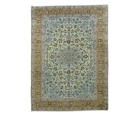 KASHAN CARPET CENTRAL PERSIA, LATE 20TH CENTURY the eau de nil field with indigo lattice medallion, similar spandrels, within