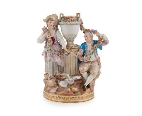 MEISSEN FIGURE GROUP OF LOVERS LATE 19TH CENTURY modelled with a fluted column and urn flanked by a pair of courting lovers h