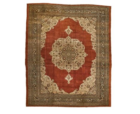 TABRIZ HADJI JALILI CARPET NORTHWEST PERSIA, LATE 19TH/EARLY 20TH CENTURY the plain rust field with cream and grey medallion,