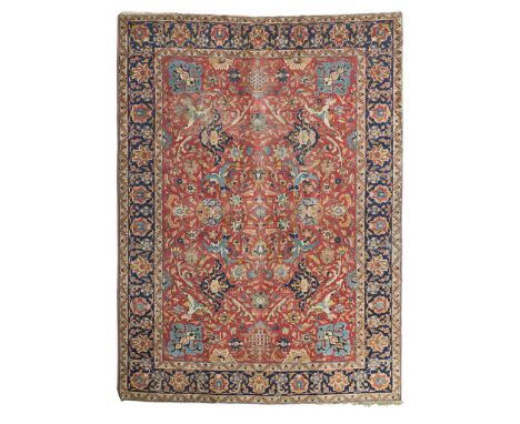 ISFAHAN CARPET CENTRAL PERSIA, EARLY/MID 20TH CENTURY the red field with allover palmette and vine pattern, within indigo bor