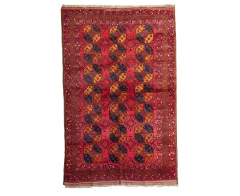 ERSARI CARPET TURKMENISTAN, EARLY 20TH CENTURY the red field with three columns of seven guls, within red border(293cm x 217c