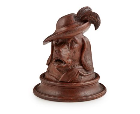 BLACK FOREST DOG-FORM INKWELL LATE 19TH/ EARLY 20TH CENTURY carved as the head of a hound wearing a feathered hat, opening to