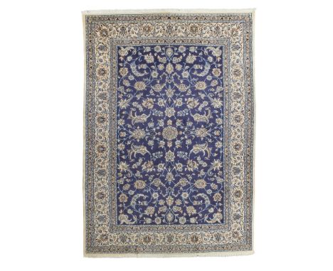 NAIN CARPET CENTRAL PERSIA, LATE 20TH CENTURY the indigo field with allover palmette and vine pattern, small rosette medallio