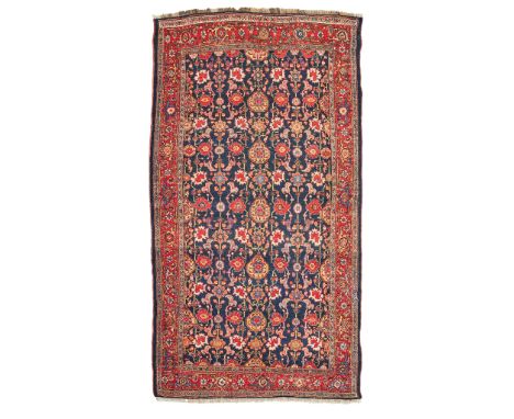 BIDJAR CARPET WEST PERSIA, LATE 19TH/EARLY 20TH CENTURY the indigo field with allover palmette and vine lattice pattern, with