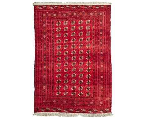 TEKKE CARPET TURKMENISTAN, EARLY/MID 20TH CENTURY the red field with five columns of thirteen guls, within multiple borders(2