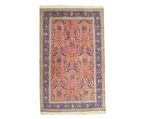 TABRIZ CARPET NORTHWEST PERSIA, MID 20TH CENTURY the salmon pink field with allover foliate 'Mustafavi' pattern, within indig