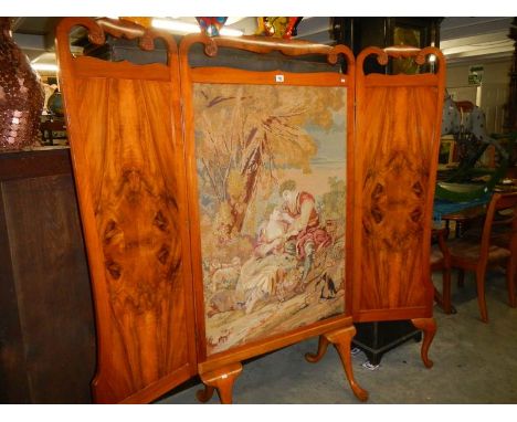 A large Victorian tapestry screen in and oak and walnut frame on pad feet.
