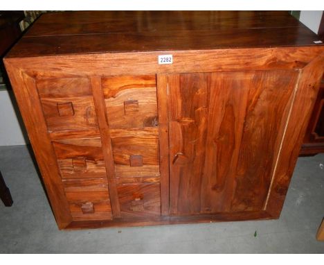 A single door cupboard with 6 spice drawers.