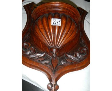 A carved wood shelf bracket.