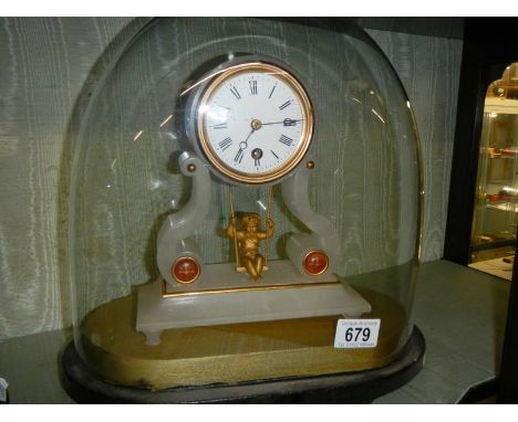 A good French alabaster mantle clock under dome with swinging cherub pendulum.