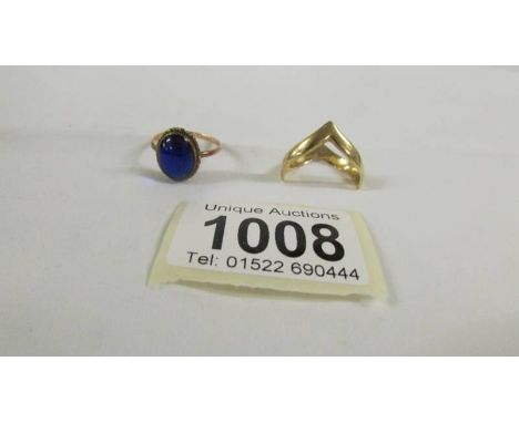 A 9ct gold ring set blue stone and a 9ct gold wishbone ring.