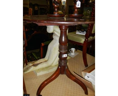 A mahogany tripod table. ****Condition report**** 2 legs have chipping at top where joining column.Metal bracket added under 