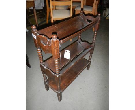 An oak book rack. ****Condition report**** Length 58.5cm.Height 72cm.Depth 11.5cm.Chipping to 1 top.Generally needs a polish.