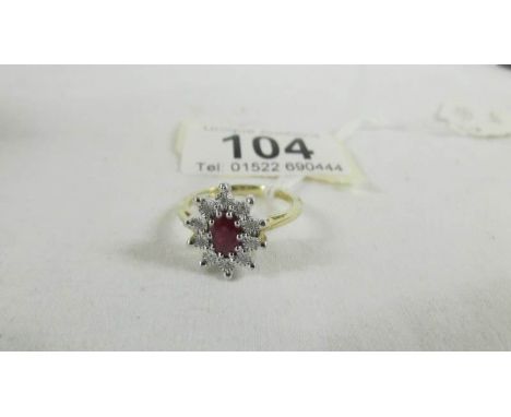 A yellow gold oval ruby and diamond ring, size O.