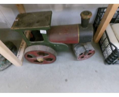 A large pre-war wood and metal steam roller.