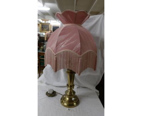 A good quality brass table lamp with lovely pink fringed shade.