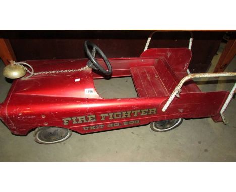 A Vintage firefighter fire engine pedal car.