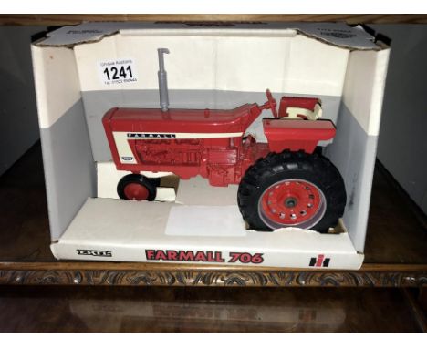 A boxed Ertl Farmall 706 tractor, model No. 2307. ****Condition report**** Scale 1/16.Approximate length 22.5cm.