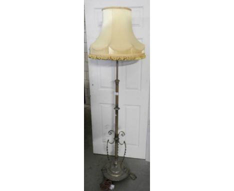 An early 20th century brass standard lamp with shade. ****Condition report**** Patinated finish, would benefit from a polish.