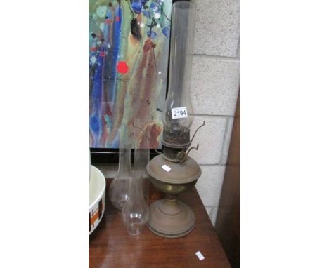 A brass oil lamp and 4 oil lamp chimneys.