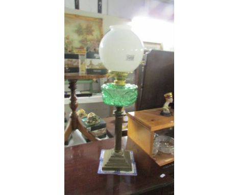 A Victorian brass column oil lamp with green glass font (burner converted to electric but font not drilled). ****Condition re