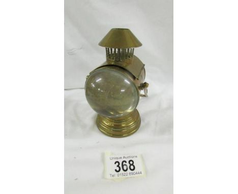 A novelty Edwardian brass inkwell in the form of a coach lamp.