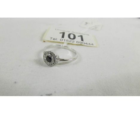 A white gold diamond and sapphire ring, size N half.