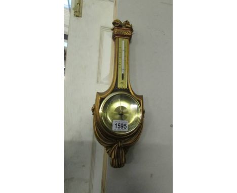 A gilded barometer.