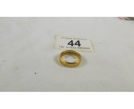 A 22 ct gold wedding ring, size M, 5.2 grams.