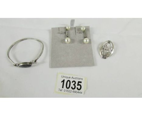 A Blue John stone bangle set in silver with silver brooch in the art nouveau style and a pair of pendant earrings.
