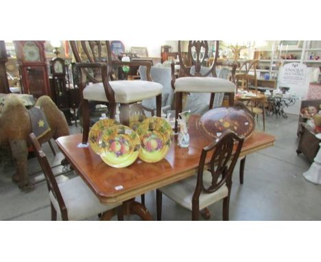 A superb quality double pedestal dining table with 6 shield back dining chairs.