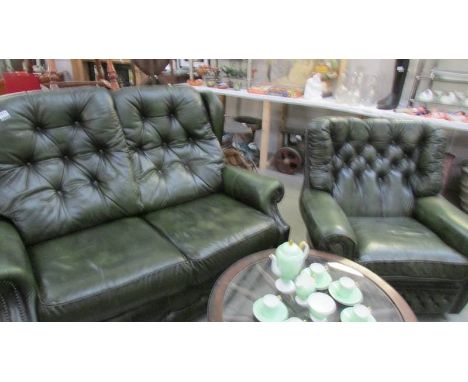 A green leather 2 seat sofa and chair.