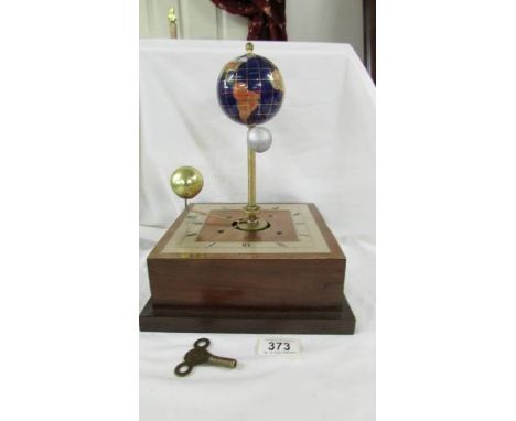 An unusual gem stone globe with moon and sun mantel clock. ****Condition report**** Moon & sun rotate around earth.Clock wind