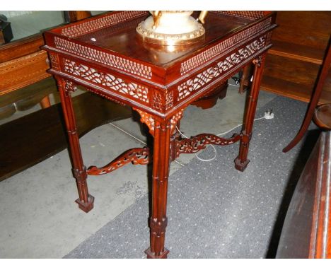 A mahogany galleried table. ****Condition report**** No missing or broken fretwork. 
No visible woodworm. 
Top clean but cent