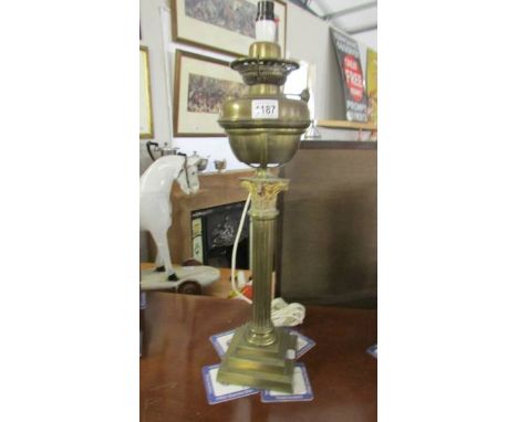 A brass Corinthian column oil lamp base converted to electric.