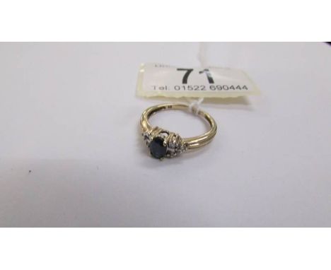 A diamond and sapphire ring set with baguettes to shoulders and round cuts in 9ct gold, size N.