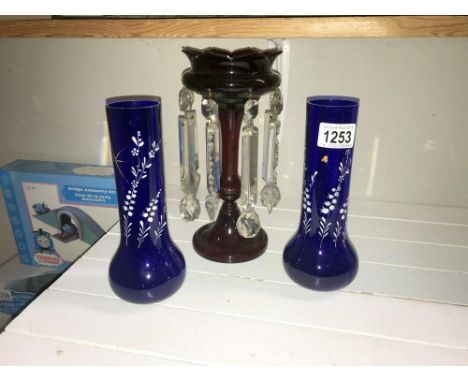 A Victorian ruby glass lustre and a pair of blue glass overlaid vases.