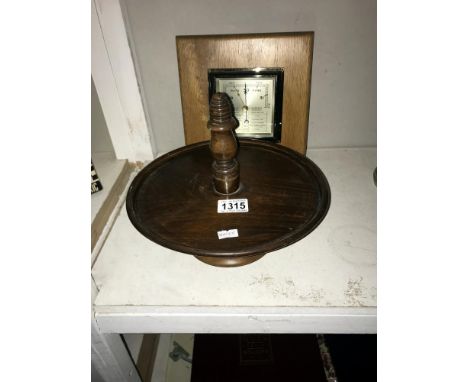 An Edwardian oak Lazy Susan cake stand and a barometer.