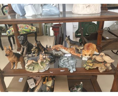 A shelf of german shepherd figures