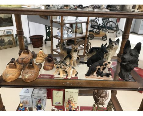 A shelf of german shepherd figures